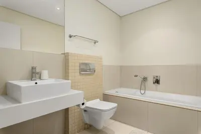 a bathroom with a sink and a toilet and a bath tub at La Cabina 105 in Cape Town
