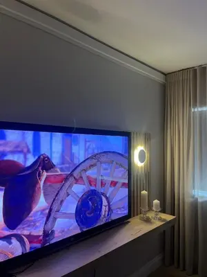 a large flat screen tv in a living room at Nomads Hermanus in Hermanus