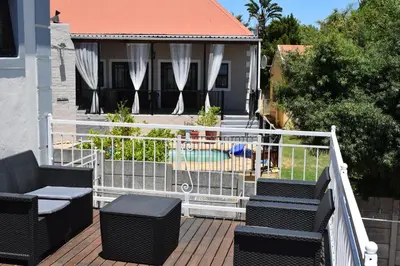 a balcony with chairs and a pool in a house at The Crest Studio in Oakdale