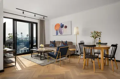 a living room with a couch and a table at Nine Palms Stunning 1-Bedroom Apartment in Century City