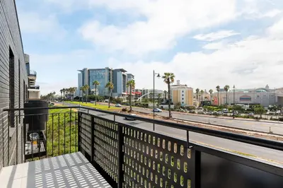 a balcony of a building with a view of a street at Nine Palms Stunning 1-Bedroom Apartment in Century City