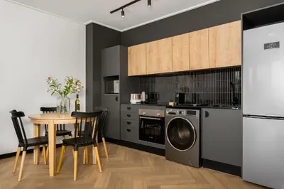 a kitchen with a table and a washing machine at Nine Palms Stunning 1-Bedroom Apartment in Century City