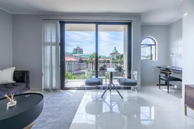a living room with a glass table and a view at St Tropez On Lake 302 The Island Club in Cape Town
