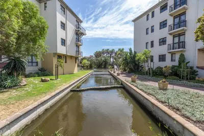 a canal in the middle of a building at St Tropez On Lake 302 The Island Club in Cape Town