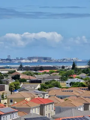 a view of a city with houses and the water at Bella View in Cape Town