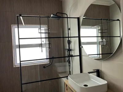 a bathroom with a sink and a mirror at Rissie's Villa in Gordonʼs Bay