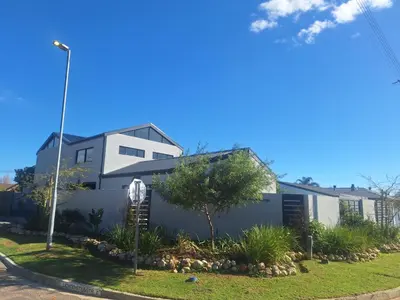 a white building with a tree in front of it at 66onjennings Strand in Strand