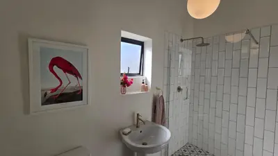 a bathroom with a sink and a toilet and a shower at Swallows Nest Garden Cottage in Helderberg