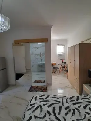 a room with a fireplace in the middle of a room at Livingsound 1bed self cat apartment in Cape Town