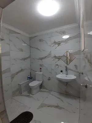 a bathroom with a toilet and a sink at Livingsound 1bed self cat apartment in Cape Town