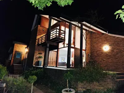 a brick house at night with the lights on at 41 on RUPERT in Helderberg