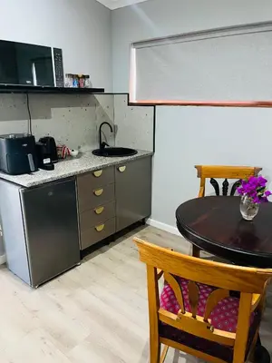a kitchen with a table and a counter top at 41 on RUPERT in Helderberg