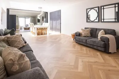 a living room with two couches and a wooden floor at Villa Noor Modern 2 Bed Luxury Retreat in Hanover Park