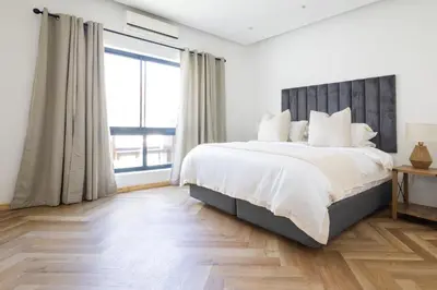 a bedroom with a large bed and a large window at Villa Noor Modern 2 Bed Luxury Retreat in Hanover Park