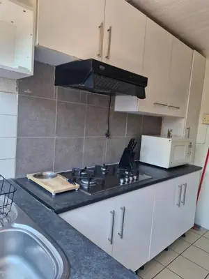 a kitchen with a sink and a stove top oven at Central, Spacious GF Apartment, access to N1,N2,M5