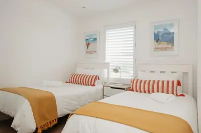 a bedroom with two beds and a window at Hermanus Beach Club 218 in Hermanus