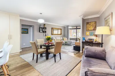 a living room with a table and chairs at Family Oasis with Pool close to Shopping Center in Cape Town