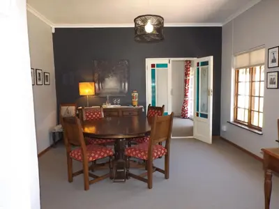a dining room with a table and chairs at Ambleside House Pinelands, Cape Town in Cape Town