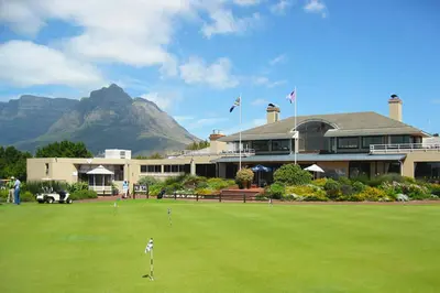 a building with a golf course with mountains in the background at Ambleside House Pinelands, Cape Town in Cape Town