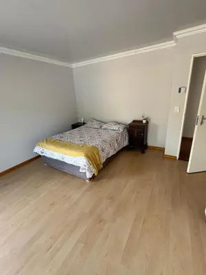 a bedroom with a bed and a wooden floor at North of the vines in Oakdale