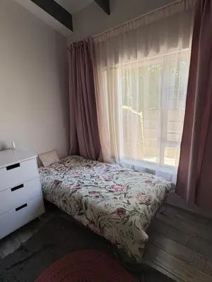a bedroom with a bed next to a window at North of the vines in Oakdale