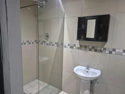 a bathroom with a shower and a sink at Maglovir economy 3 BEDROOMS BULK in Tiervlei