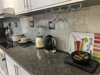 a kitchen counter with a blender on top of it at Beach Walk Guest House & Apartments in Cape Town