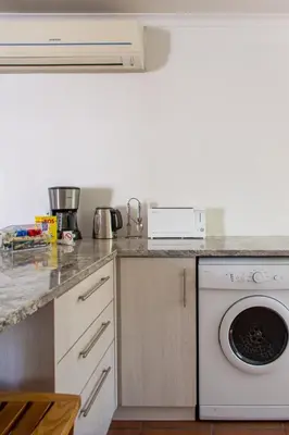a kitchen with a dishwasher and a washer at Stellenbosch Cottage, Entire House and Garden in Stellenbosch