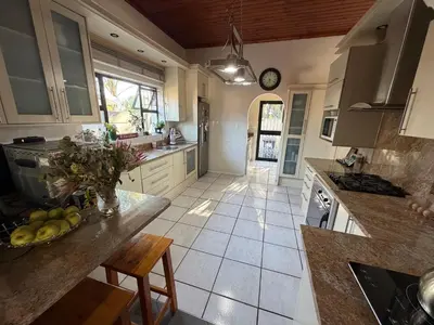 a kitchen with a table and a counter top at Family Home with Big Garden & Jacuzzi in Welgelegen
