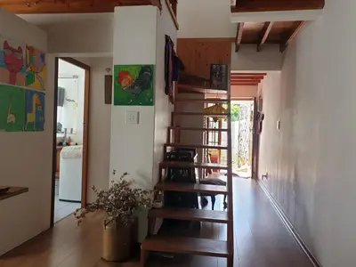 a room with a spiral staircase in a house at Cozy family home in Cape Town