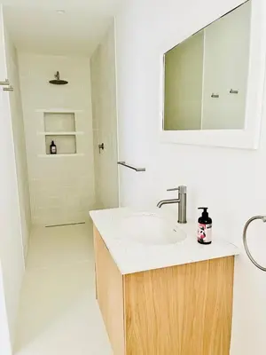 a bathroom with a sink and a mirror at Northcliff House in Hermanus