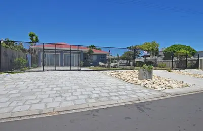 a fence in front of a parking lot at Briza Breeze in Cape Town