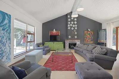 a large living room with couches and a fireplace at Briza Breeze in Cape Town