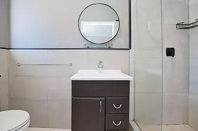 a bathroom with a sink and a mirror at Briza Breeze in Cape Town