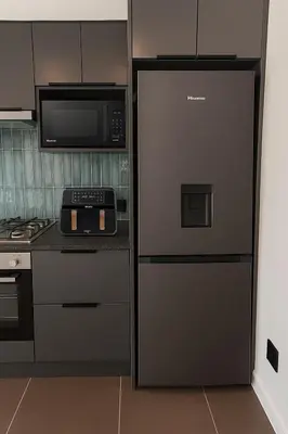 a kitchen with a refrigerator and a microwave at Majestic Mountain views in the Cape Town Winelands in Stellenbosch