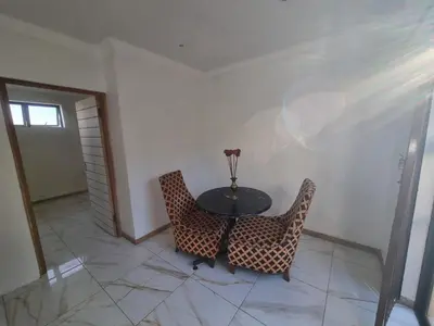 a dining room with a table and two chairs at Bird Retreat in Zeekoevlei