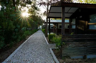 a walkway next to a building with the sun shining at The Lineage Lodge in Elgin