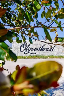 a sign for the alverneeland sign behind a tree at Olijvenkraal Winelands Lodge in Paarl