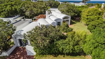 an aerial view of a white house with trees at Birdsong in Hermanus