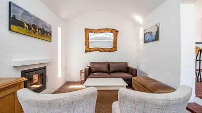 a living room with a couch and a fireplace at Birdsong in Hermanus