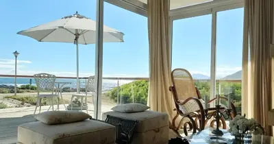 a living room with a view of the ocean at 138 Marine Beachfront Guesthouse in Hermanus