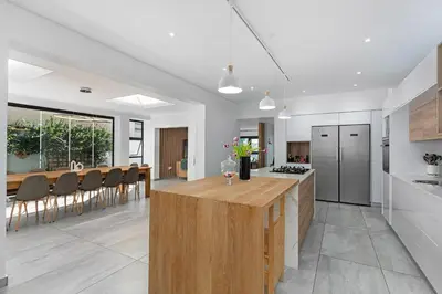 a kitchen and dining room with a table and chairs at Sunset Sundowners Villa in Cape Town