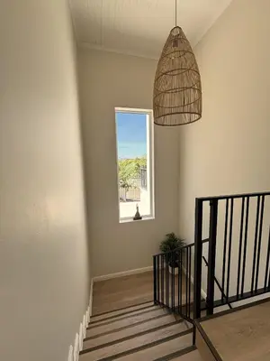 a staircase with a window and a potted plant at Golden Hillside in Somerset West