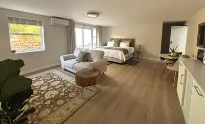 a living room with a bed and a couch at Golden Hillside in Somerset West