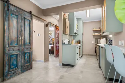 an open kitchen with an old door in a room at Waves and Wildflowers in Cape Town