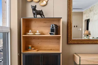 a book shelf with a statue of a dog on it at Waves and Wildflowers in Cape Town