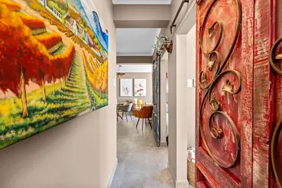 a hallway with a painting hanging on a wall at Waves and Wildflowers in Cape Town