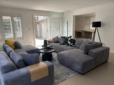 a living room with two couches and a table at Providence in Hermanus