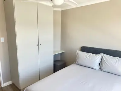 a bedroom with a bed and a closet at Odeon Ocean View in Strand