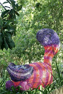 a colorful dress statue sitting in the grass at Le Grand Jardin Villa in Kayamnandi